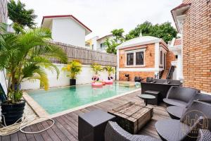 胡志明市的住宿－KN2 HOLIDAY VILLA，一个带游泳池和房子的后院