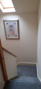 a hallway with a picture of a flower on the wall at Henblas Holiday Cottages in Abergele
