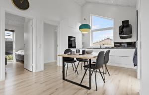 a kitchen and dining room with a table and chairs at Awesome Home In Otterup With Wifi in Otterup