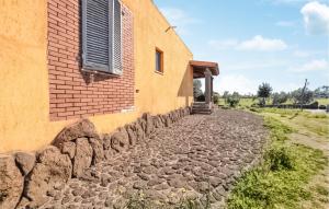 a building with a window and a stone walkway at 1 Bedroom Pet Friendly Home In Orosei in Orosei +6 photos