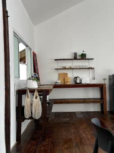 a dining room with a wooden table and a window at The Sol on the sea - Koh Lanta in Ko Lanta