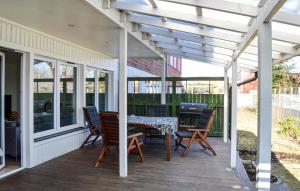a patio with a table and chairs on a deck at 2 Bedroom Amazing Apartment In Skrholmen in Stockholm