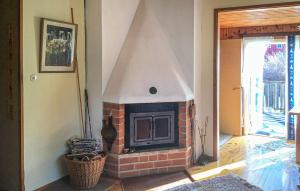 a brick fireplace in the corner of a room at 1 Bedroom Amazing Home In Väddö in Väddö