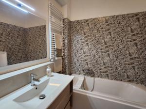 a bathroom with a sink and a toilet and a tub at The Blue Room in Porto SantʼElpidio