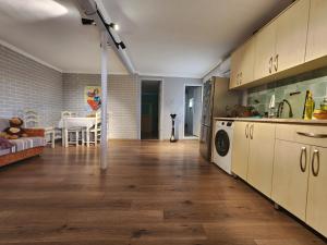 a kitchen with wooden floors and a living room at my home in Kutaisi
