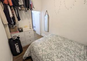 a bedroom with a bed and a dresser and a mirror at 1 Bedroom Apartment East Village Union Square in New York