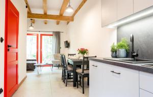 a kitchen with a table and a dining room at Cozy Home In Rowy With Kitchen in Rowy
