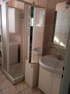 a bathroom with a shower and a sink and a toilet at Casa vacanza Leonida in Carrara +39 photos