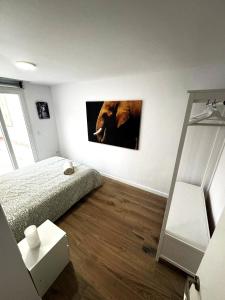 a bedroom with a bed and a picture of a bear on the wall at Benicasim Village in Benicàssim