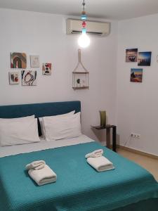 a bedroom with a bed with two towels on it at Δροσιά in Nafplio