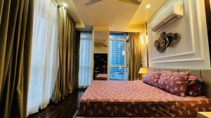 a bedroom with a bed and a large window at Sky Heights Executive Apartments Facing Centaurus Mall Islamabad in Islamabad