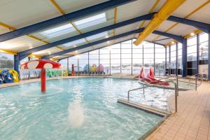 a large swimming pool with a water slide at Swn y Mor (Glamorgan 23) in New Quay
