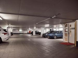 a parking garage with several cars parked in it at Good Seasons Hotel Den Bosch in Den Bosch +187 photos