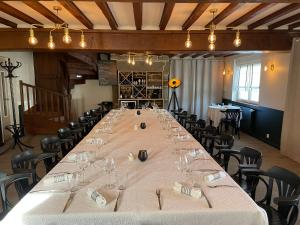 a large long table in a room with chairs at Restaurant Hotel Logis Chez Sophie in Briouze