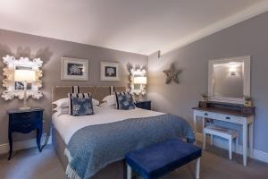 a bedroom with a bed with a blue blanket and a mirror at Twenty One in Richmond +32 photos