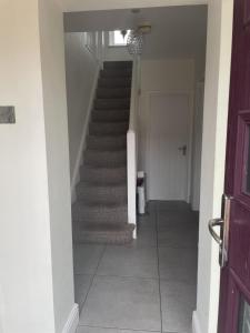 a hallway with a staircase in a house at ACCOMADATION WREXHAM in Wrexham