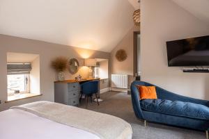 a bedroom with a bed and a couch and a desk at Fairfield House in Newsham