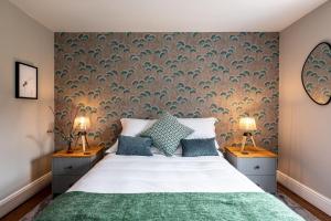 a bedroom with a large bed with two lamps at Fairfield House in Newsham
