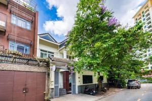 a house with a garage and a tree at KN3 Holiday Villa in Ho Chi Minh City