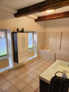 a kitchen with a sink and a bath tub at Fewo am Fuße der Burg Stargard in Burg Stargard