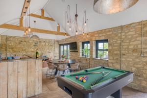 a kitchen with a pool table in a room at The Farmhouse in Ravensworth