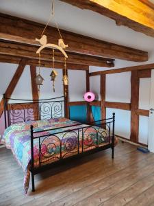 a bedroom with a bed in a room with wooden ceilings at Fewo am Fuße der Burg Stargard in Burg Stargard