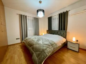 a bedroom with a bed and a large window at Platform 357 La Vie Royale Charming Apartment in Nicosia