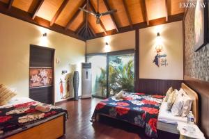 a bedroom with two beds and a window at EKO STAY- BALI VILLA in Alibaug