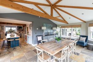 a kitchen and dining room with a wooden table and chairs at Harelands in Aldbrough