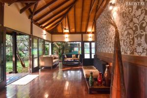 a living room with a couch and a table at EKO STAY- BALI VILLA in Alibaug