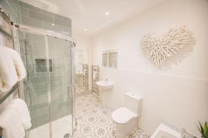 a bathroom with a shower and a toilet and a sink at Kingfisher in Forcett +28 photos