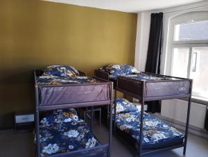 three bunk beds in a room with a window at Stadtblick 1 Monteuersfreud in Eisenberg