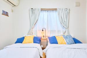 Postel nebo postele na pokoji v ubytování Comfy Home Koiwa