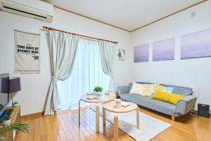 a living room with a couch and a table at Comfy Home Koiwa in Tokyo