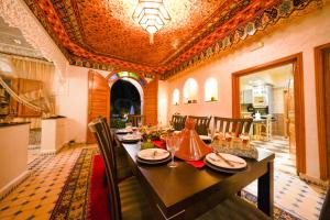 a dining room with a long table with chairs at Villa Timskrine - Panoramic Mountains View in Marrakesh