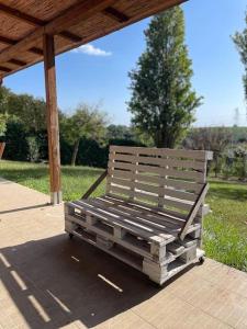 a wooden bench sitting under a gazebo at Tenuta Agave in Ardea