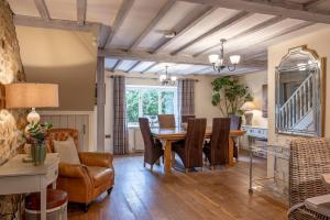 a dining room with a table and chairs at Sun Hill Cottage in Leyburn