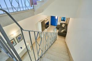 an overhead view of a staircase with a living room at Seafront Townhouse in Birzebbuga in Birżebbuġa