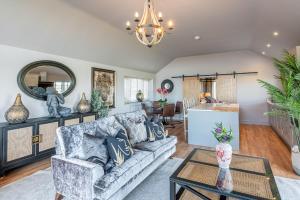 a living room with a couch and a table at Bearskin Cottage in Leyburn