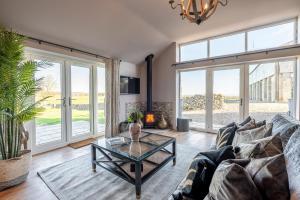 a living room with a couch and a table at Bearskin Cottage in Leyburn