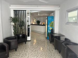 a waiting room with black chairs and a counter at SB Arenal in El Arenal