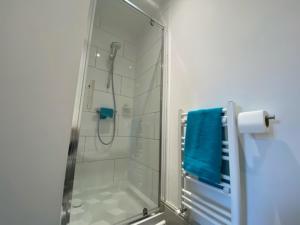 a shower with a glass door in a bathroom at 77 Underwood Lane in Crewe