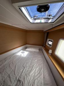 a small bed in the middle of a room with a window at Au coeur de Cannes - Le Lagoon in Cannes