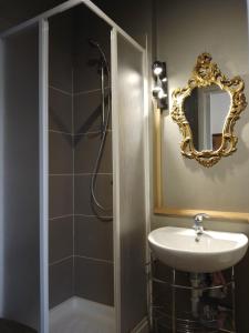 a bathroom with a sink and a shower with a mirror at Cjase Paola in Cassacco