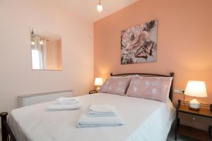 a bedroom with a bed with two towels on it at Al Centro Zante city flat in Zakynthos