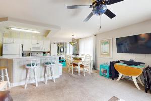 a kitchen and living room with a ceiling fan at Tee Time Beach Time in Calabash