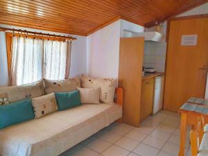 a living room with a couch and a window at Nina Apartments in Neo Klima