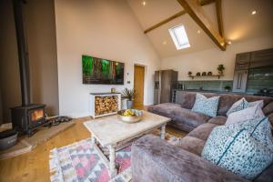 a living room with a couch and a fireplace at Millfield Barn in Richmond
