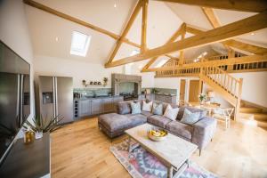 a living room with a couch and a table at Millfield Barn in Richmond