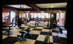 a gym with treadmills and machines in a room at Hotel Chef Knife (Part of Querencia Precinct) in Gonikoppal